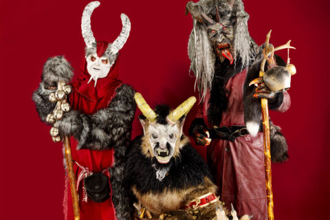 Three people dressed as Krampus monsters