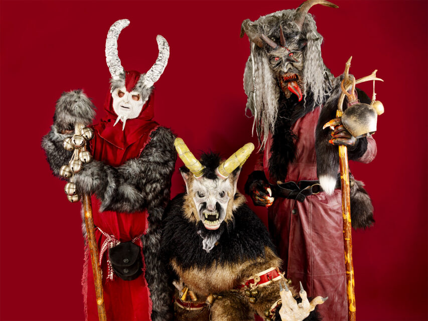 Three people dressed as Krampus monsters
