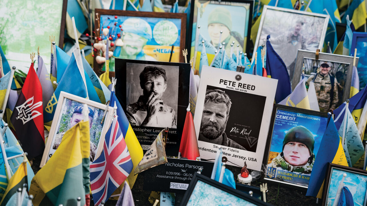 Photos and flags at a memorial in Ukraine