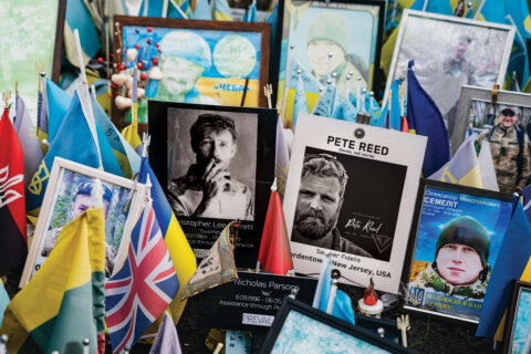 Photos and flags at a memorial in Ukraine