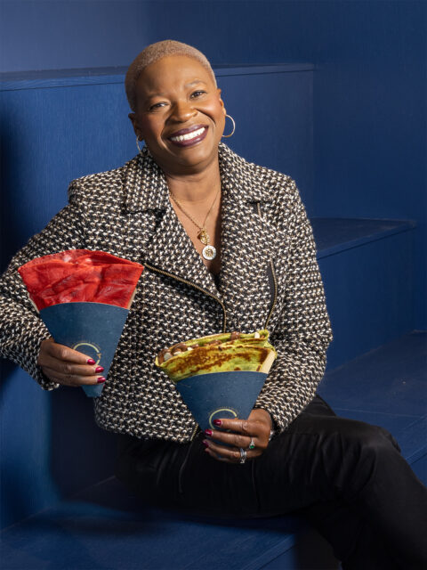 Crepe Therapy Café chef and owner Mawa McQueen holds red velvet and matcha green tea crêpes