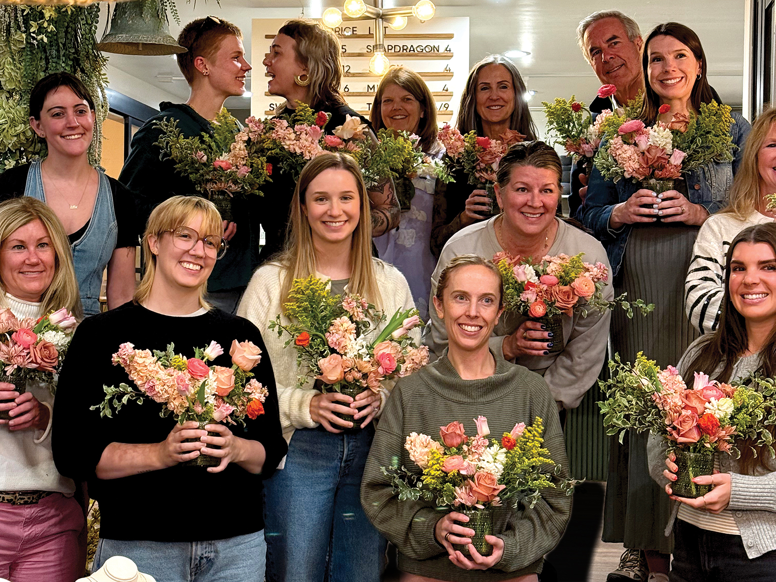 People holding floral arrangements