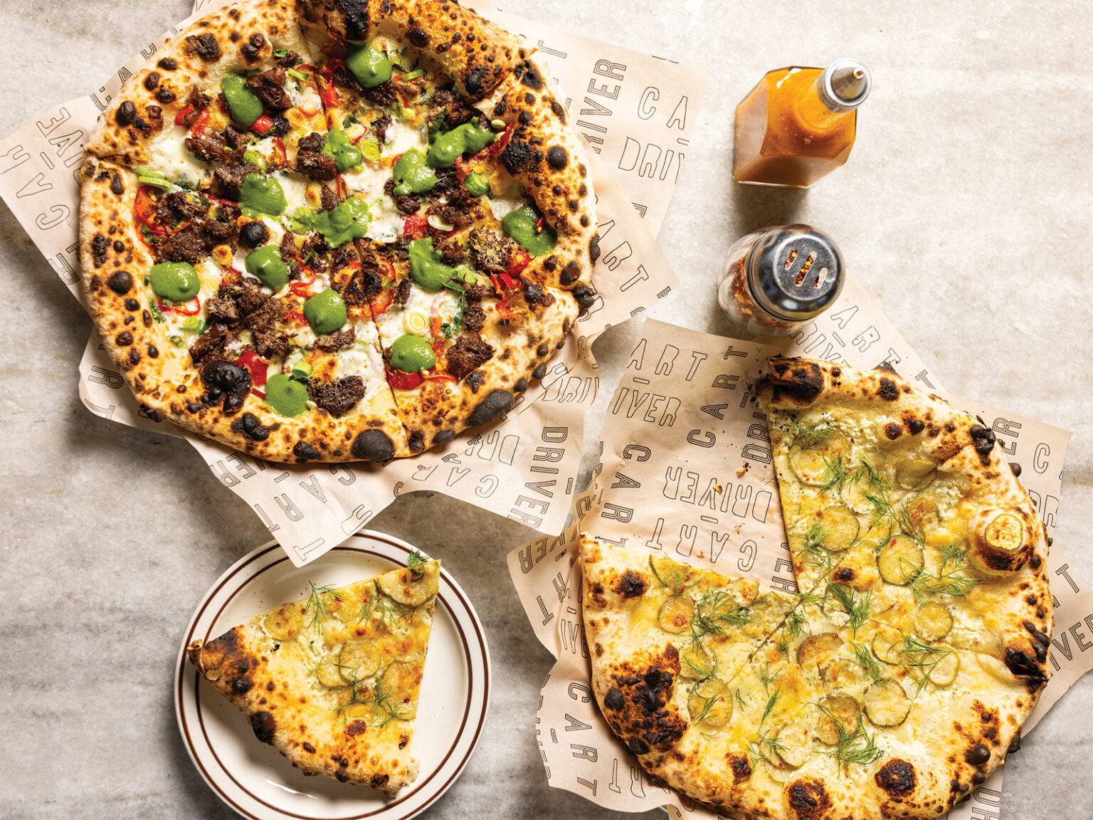 A seasonal pie with beef shank and arugula pesto and the pickle pizza