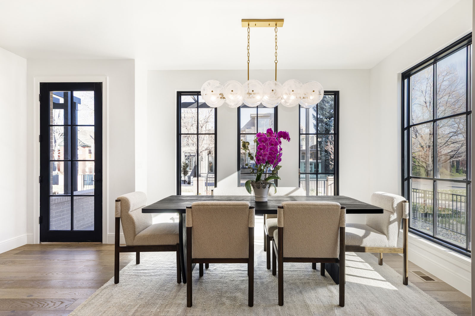Modern dining room with three large windows