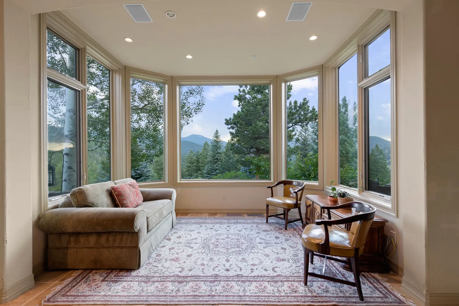 Sitting room with windows for walls
