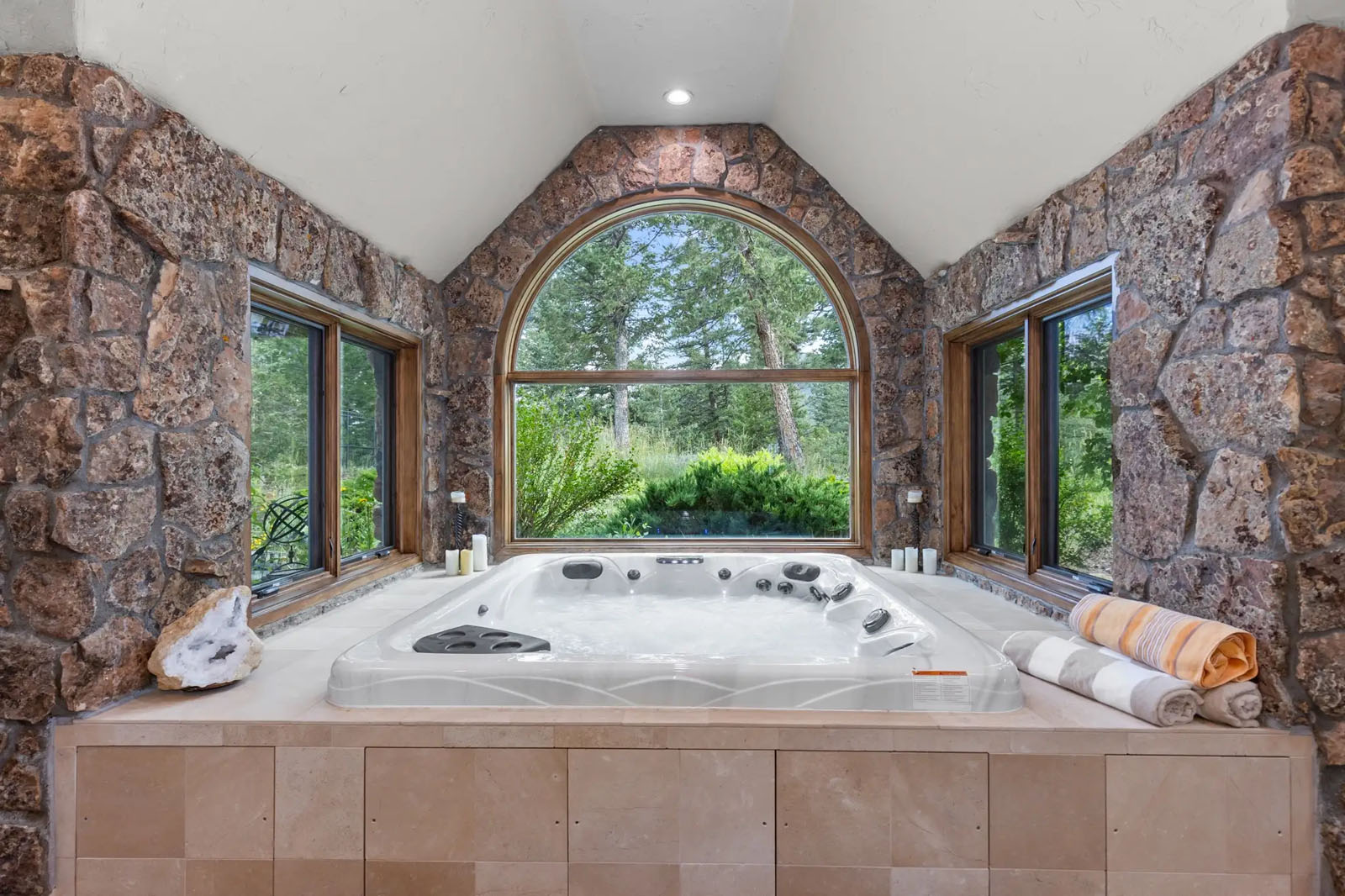Indoor hot tub surrounded by windows