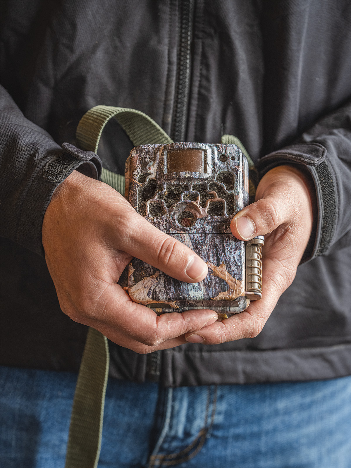 A man holds a game camera