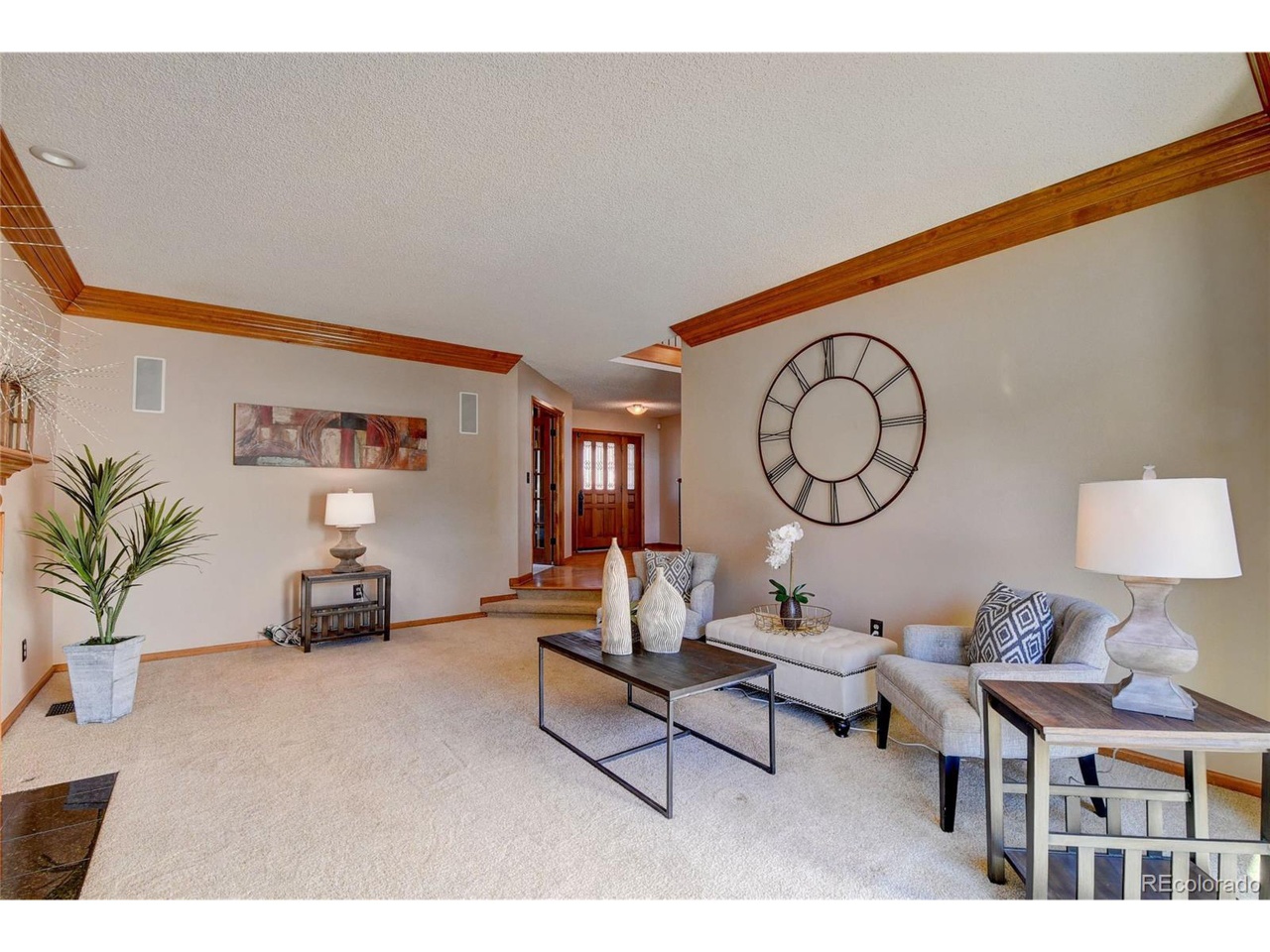 Formal living room with sparse furniture and wood molding