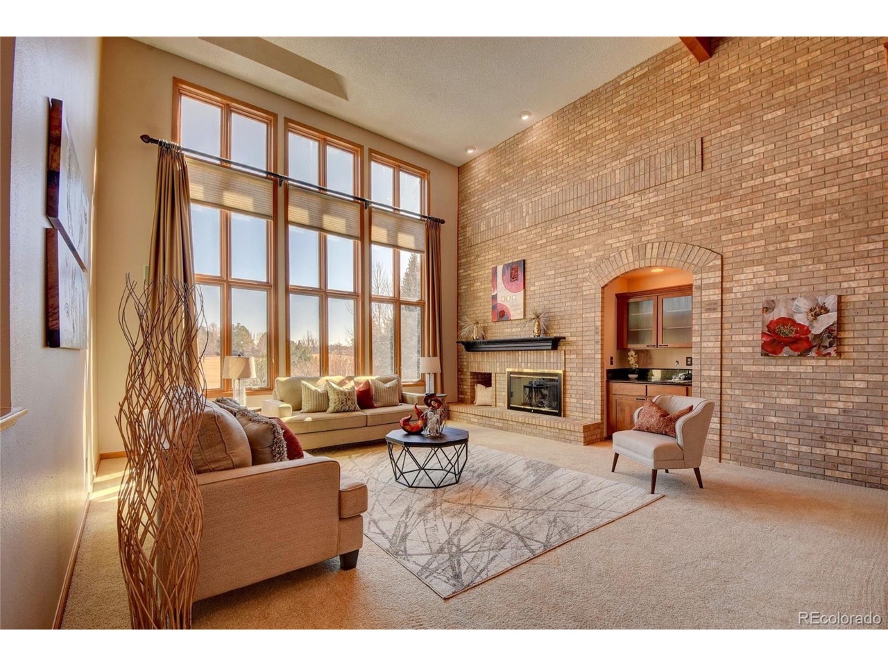 A stone great room with floor-to-ceiling windows