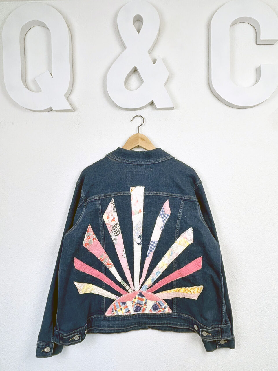 A denim jacket with a quilted pattern on the back
