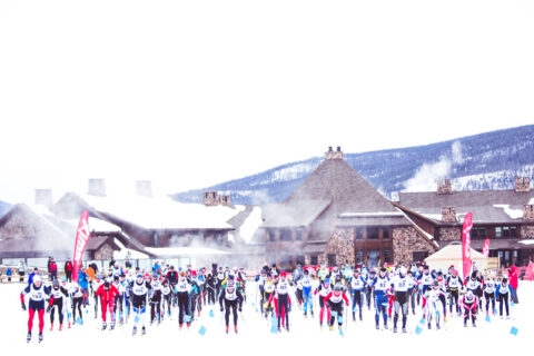 A group of people preparing to start a race in the snow.