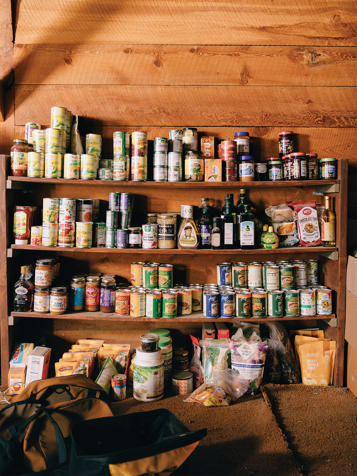Shelf-stable cans of food on wooden shelves
