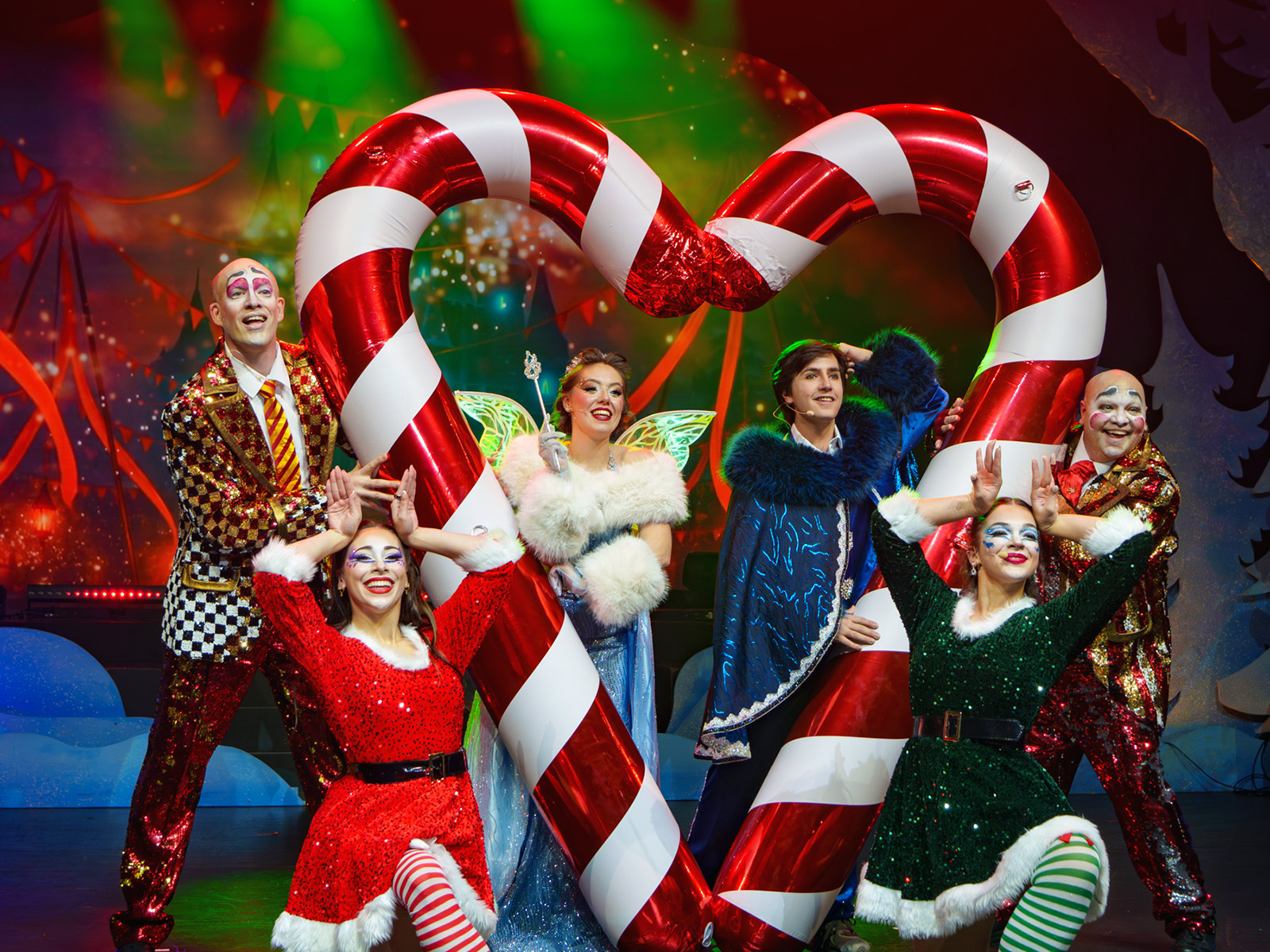 Performers in front of a candy cane heart