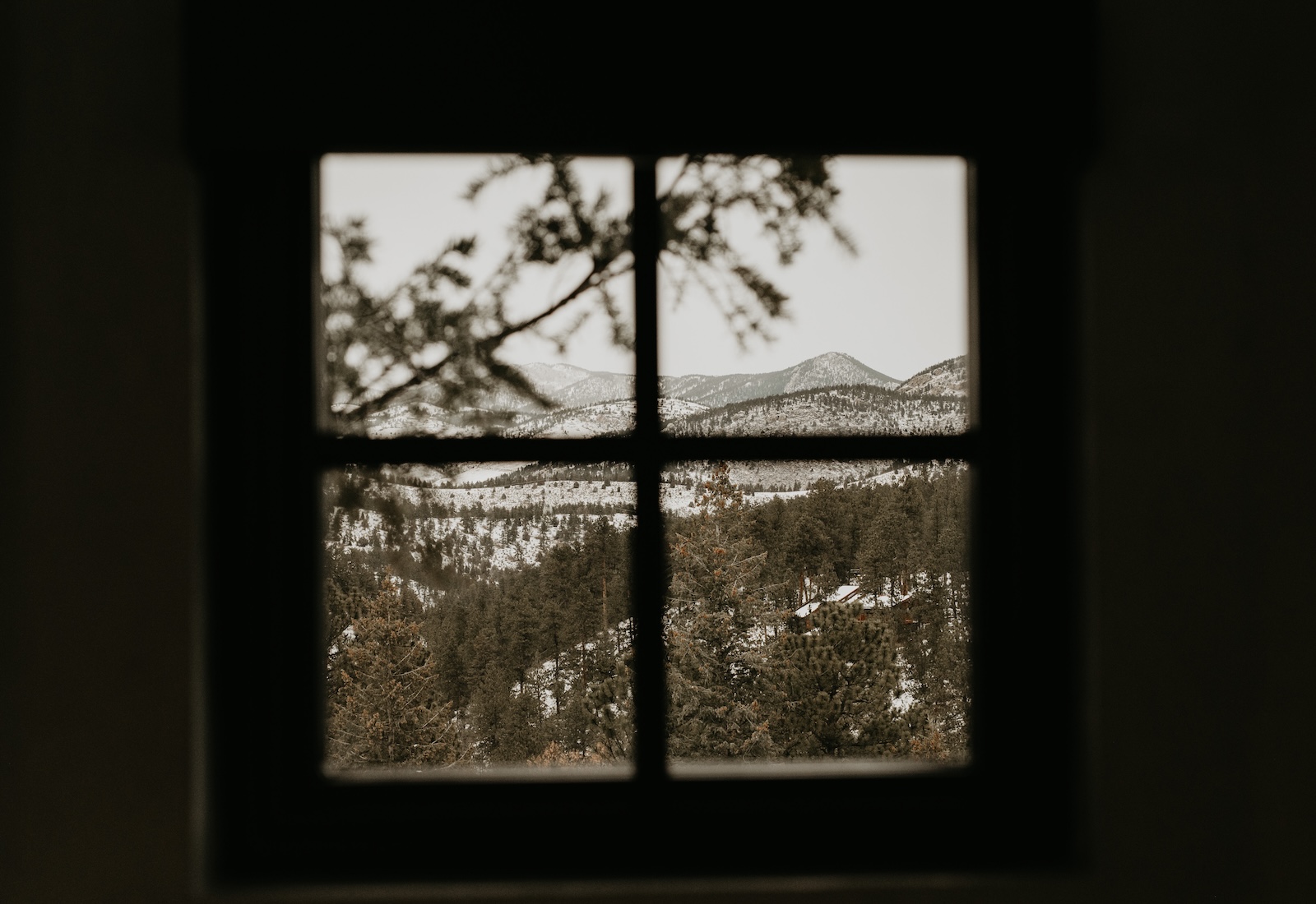 A mountain view through a window