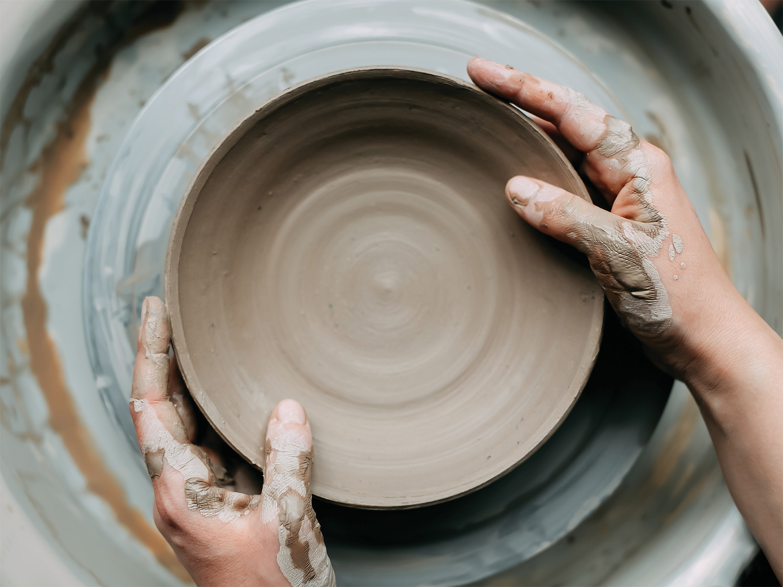 Hands on a pottery wheel