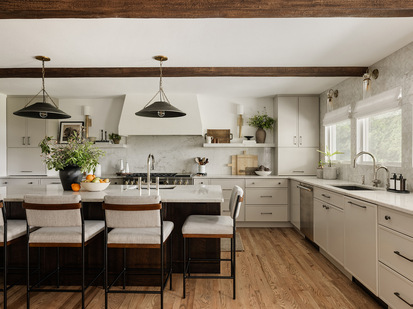 White kitchen island with high-top chairs