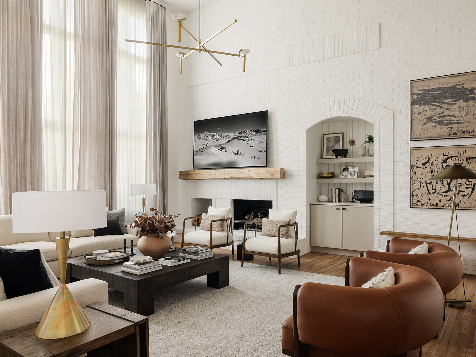 All-white living room with earthy tone furniture