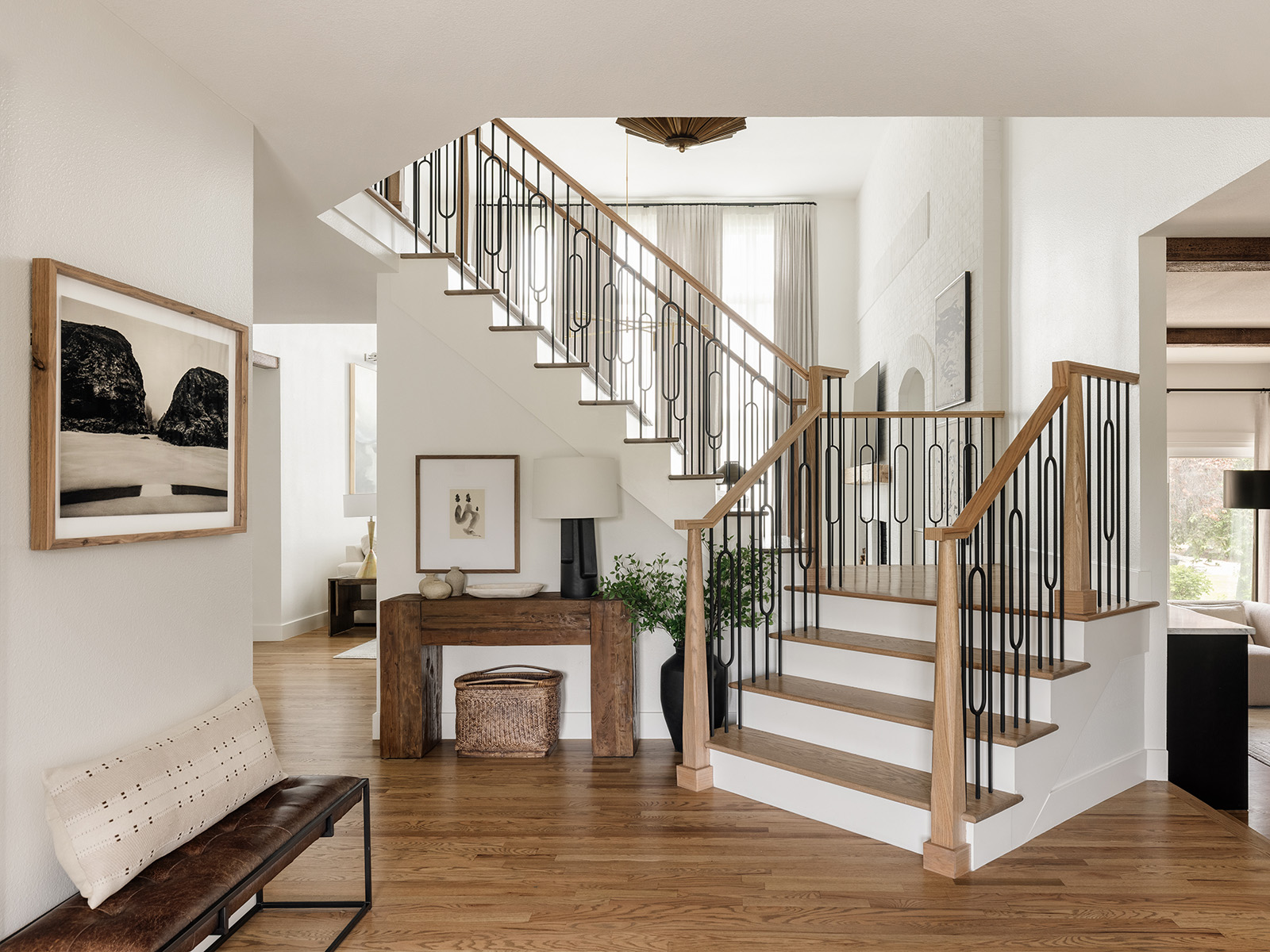 A modern entryway with a white stairwell