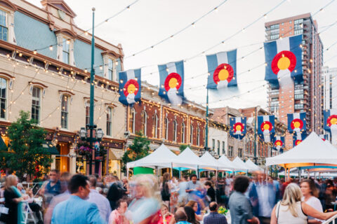 A crowd of people outside at a food event.