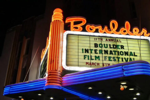 A movie theatre in Boulder, CO with a sign promoting the Boulder International Film Festival.