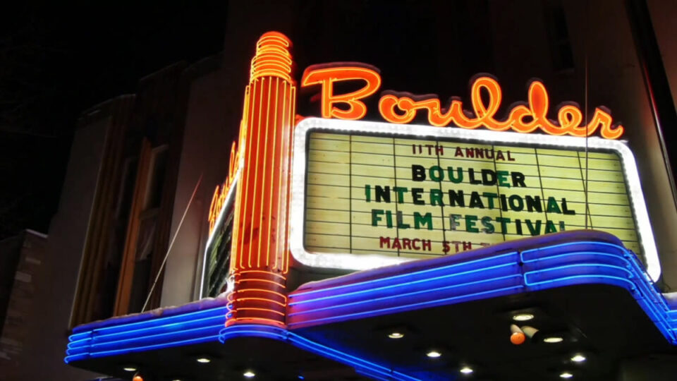 A movie theatre in Boulder, CO with a sign promoting the Boulder International Film Festival.