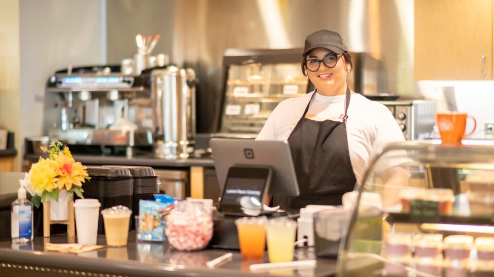Odilao Colato smiles behind the register at LatinA Flavor Cafe