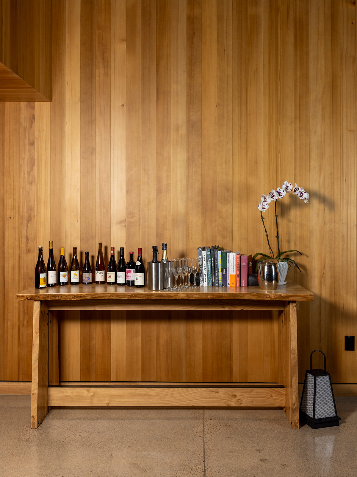 A table filled with wine bottles and a vase