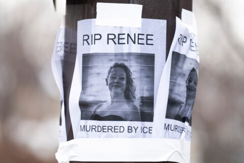 A portrait of Renee Nicole Good taped on a light pole