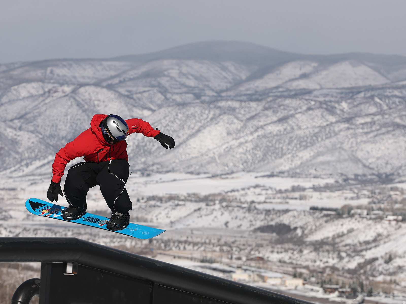 Jake Canter rides a rail on a snowboard at the X Games