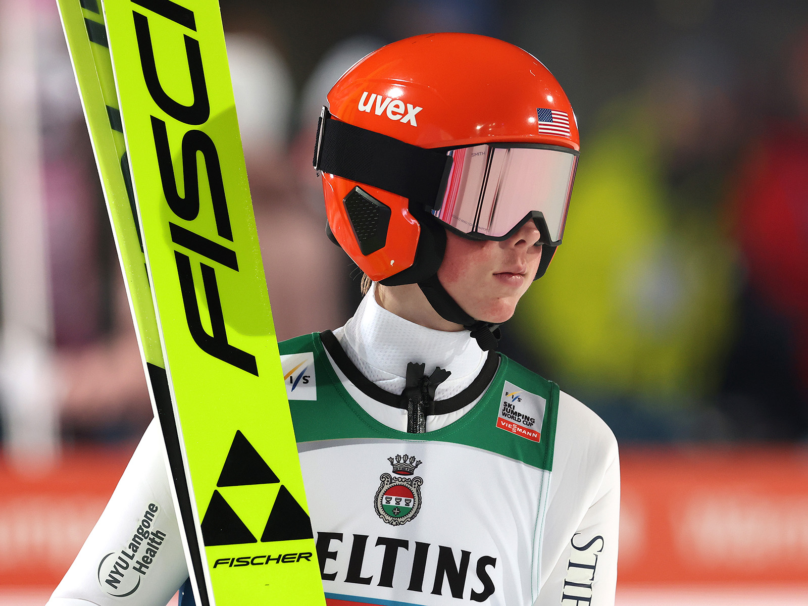 Jason Colby in a helmet, goggles, and holding skis