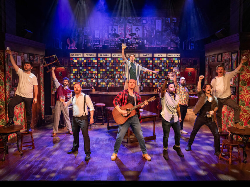 Troupe of men sing in a bar