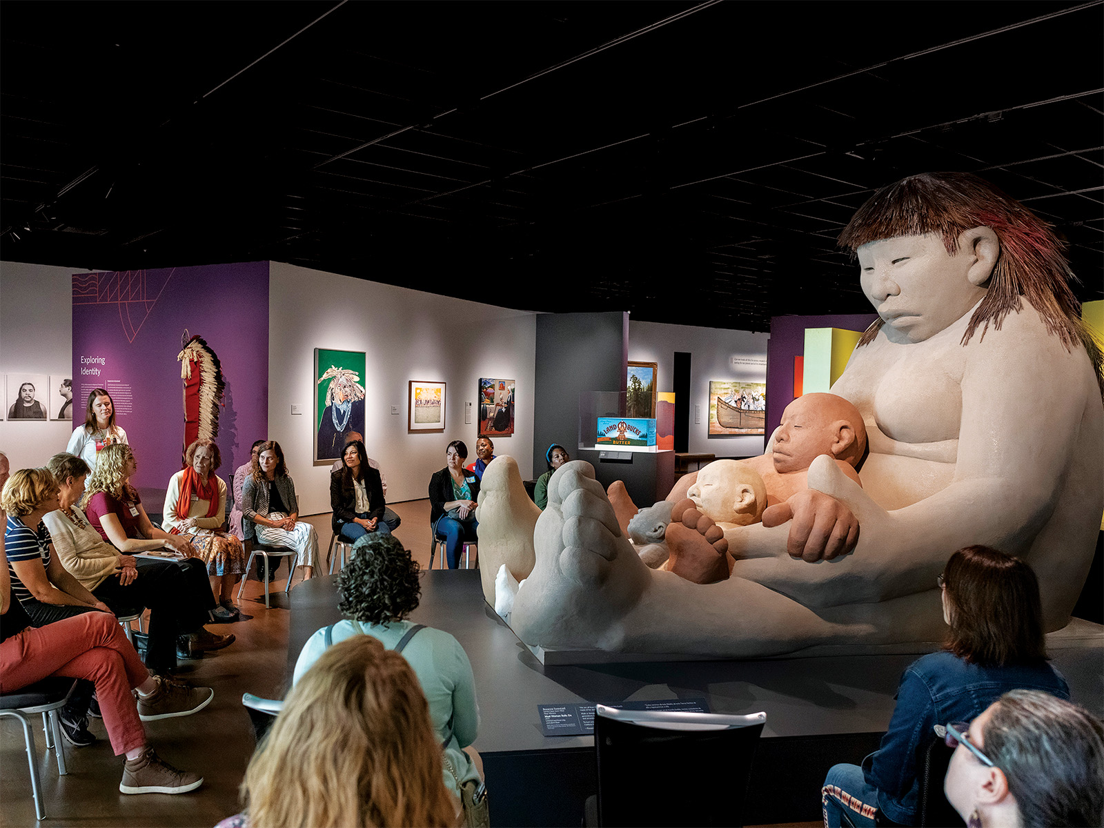 People gathered around a sculpture 