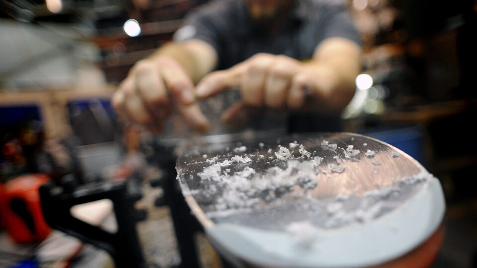 Scraping wax off a ski