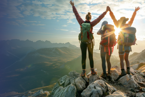Three people standing on top of a mountain.