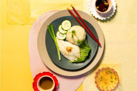 Rice, chicken, and cucumbers on a yellow background