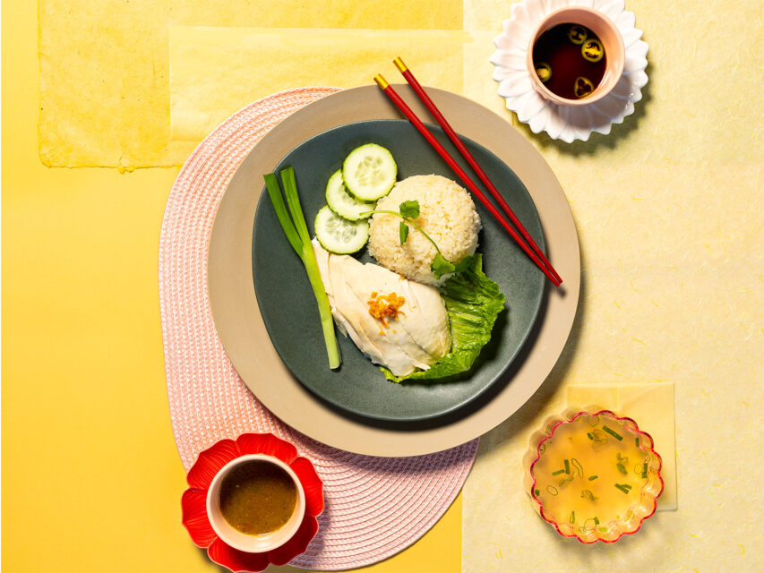 Rice, chicken, and cucumbers on a yellow background