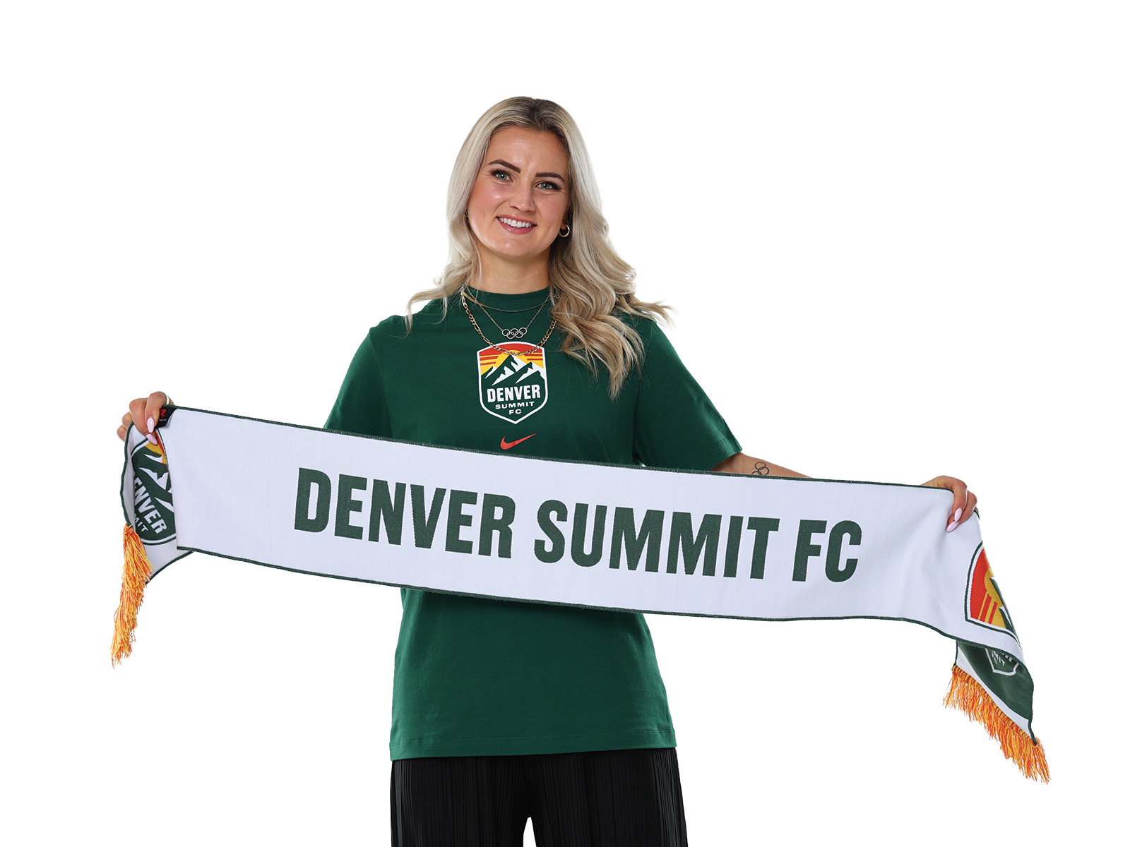 Lindsey Heaps holding a Denver Summit FC banner