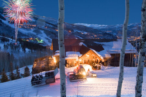 Alpine cabin with fireworks in the background
