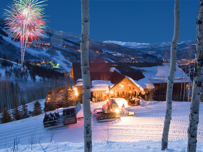 Alpine cabin with fireworks in the background