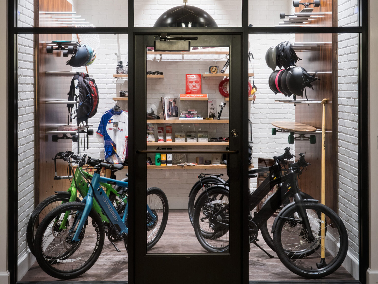A gear garage filled with bikes, longboards, helmets, and more.