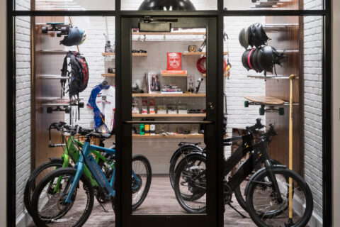 A gear garage filled with bikes, longboards, helmets, and more.