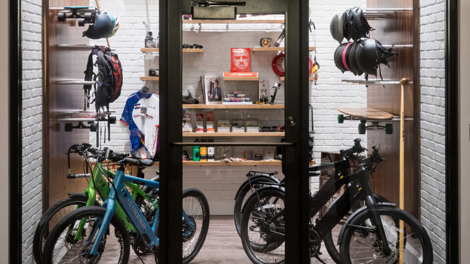 A gear garage filled with bikes, longboards, helmets, and more.