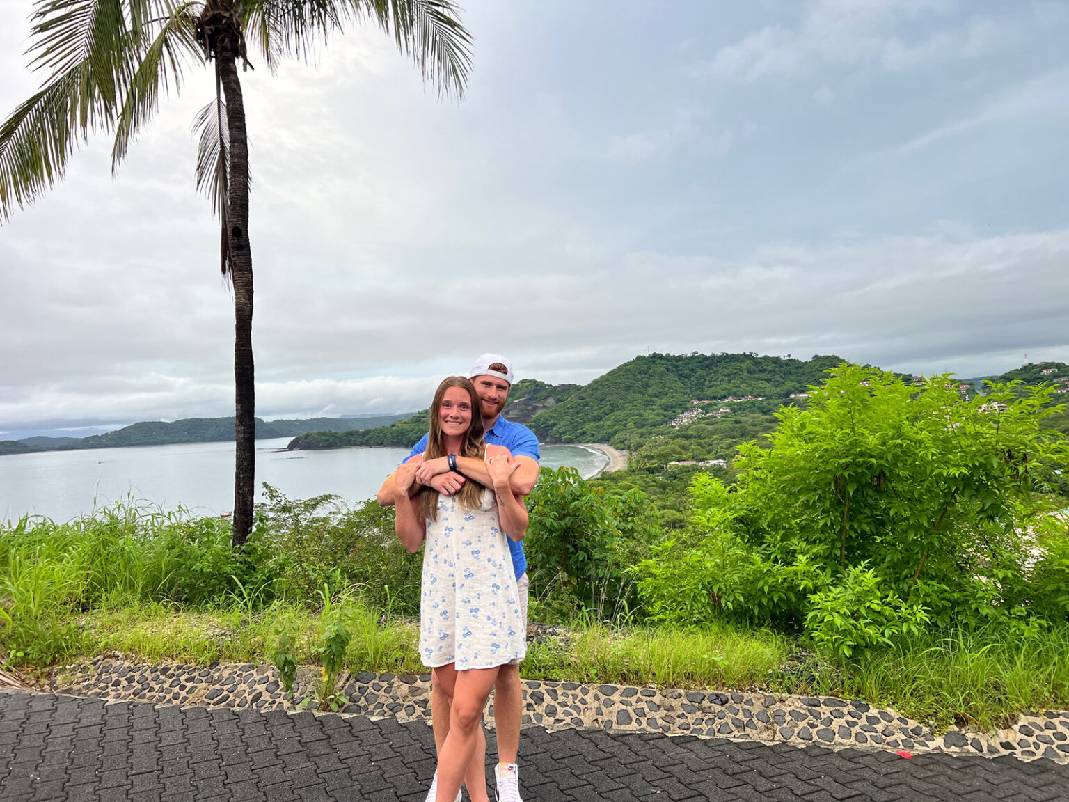 Valerie Turgeon and Garrett Klee hug in a tropical destination