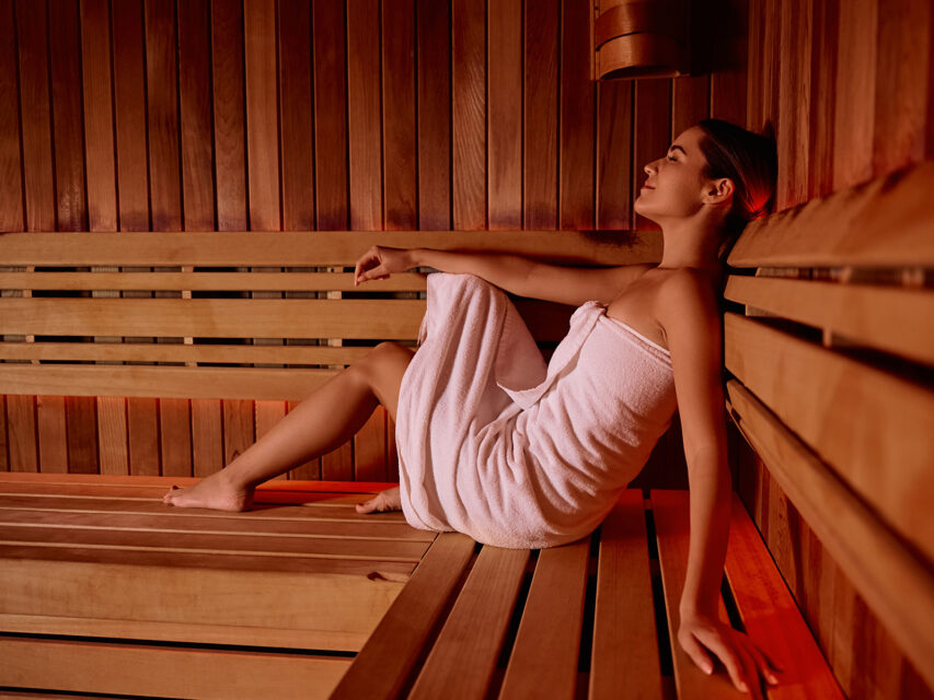 Woman relaxes in a sauna