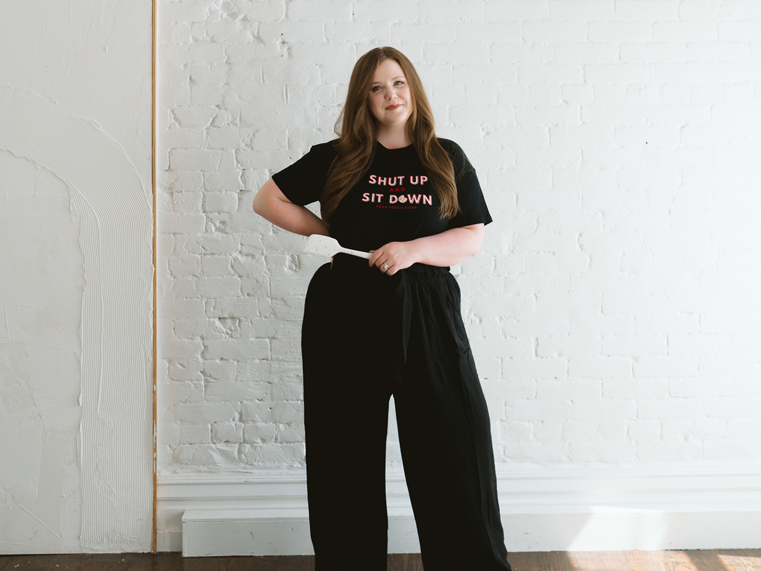 Shelby Boolay poses in a shirt that says "Shut Up and Sit Down"