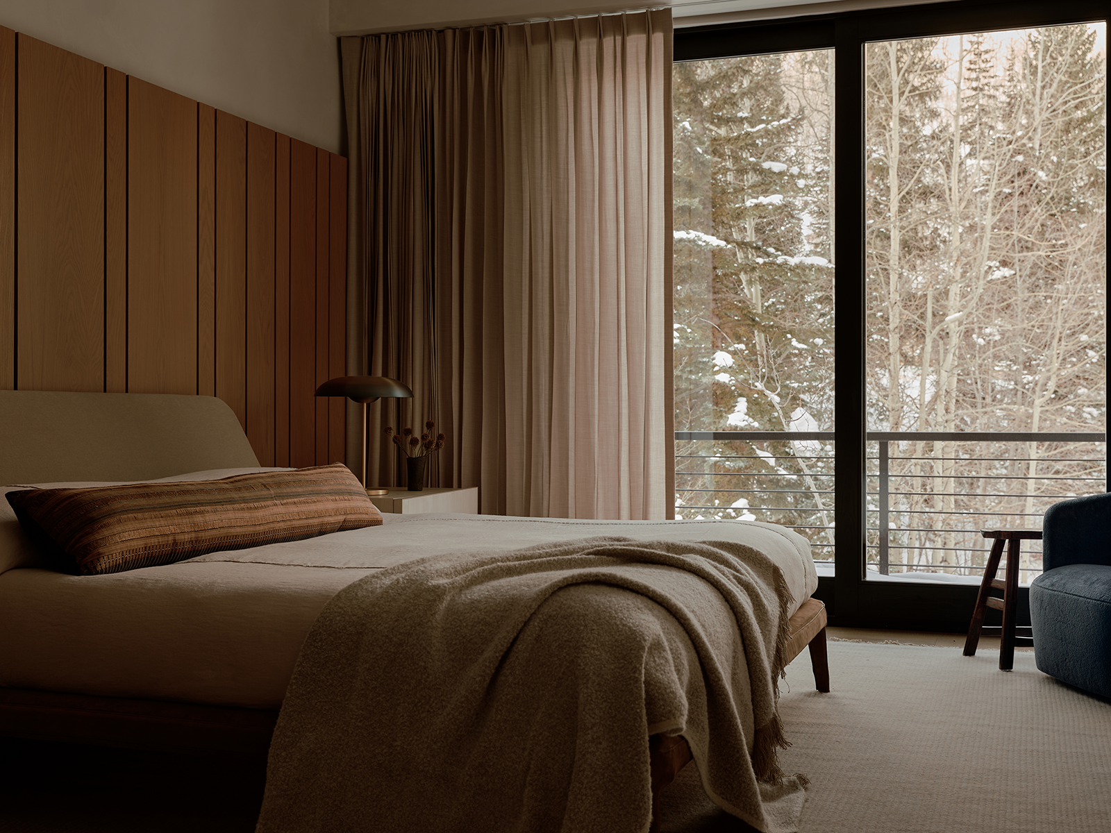 Bedroom with earth-toned furniture and a sliding glass door