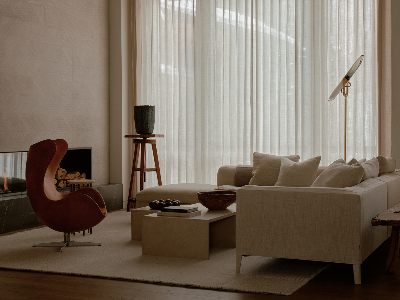 Minimalist living room with a white sofa and earth-tone furniture