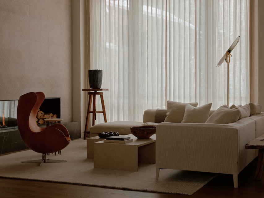 Minimalist living room with a white sofa and earth-tone furniture