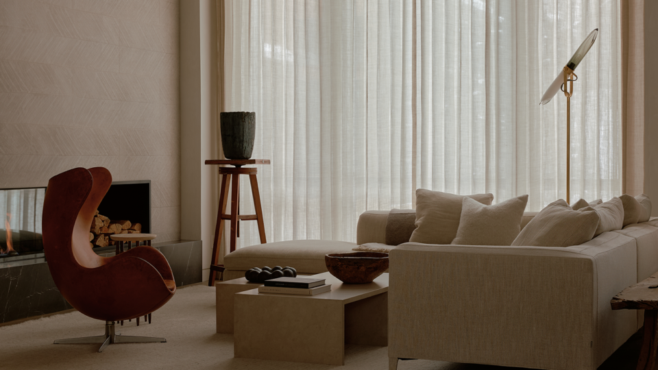 Minimalist living room with a white sofa and earth-tone furniture