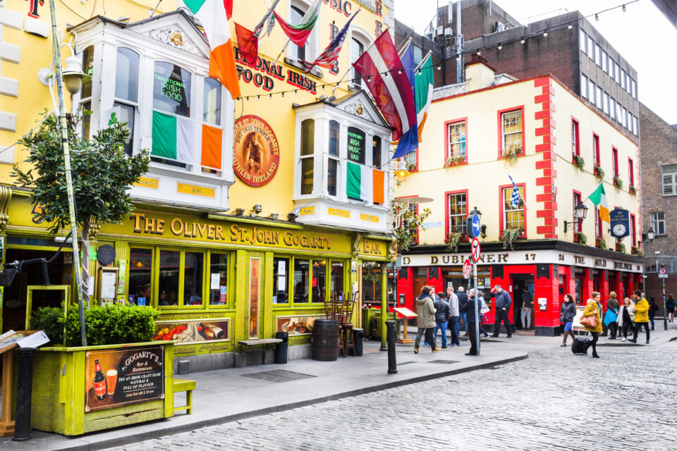 DUBLIN, IRELAND - MAY 05, 2016: Tourists walking in the Temple Bar area. The place is the cultural quarter in the center of the city and is full of restaurants bars and nightclubs.
